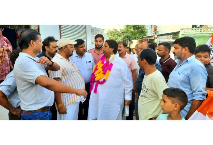 Cong candidate Raman Bhalla during door to door campaign in R S Pura.