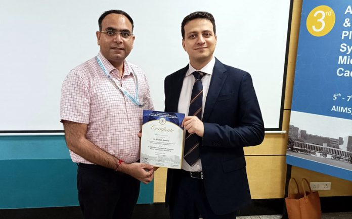 Dr Gautam receiving certificate of participation from Dr Shayan Barootchi.