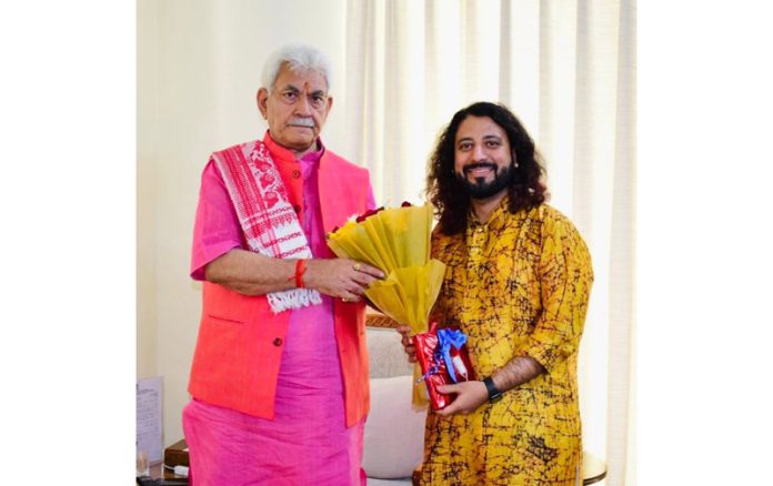 Saurabh Zadoo, vocalist and music composer presenting a bouquet to Lt Governor at Raj Bhawan on Monday.