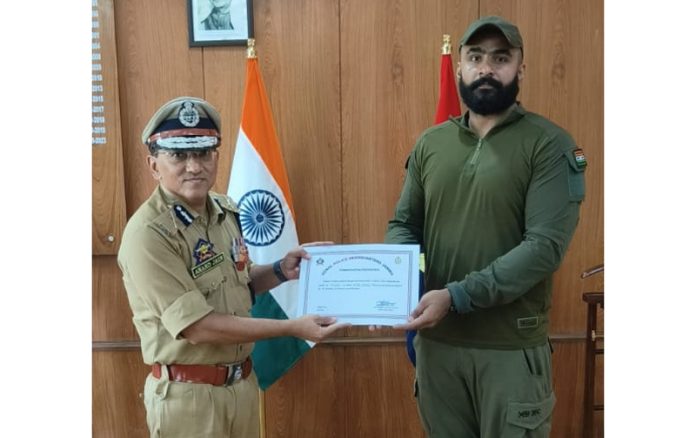 ADGP, Anand Jain awarding commendation certificate to PSI Nitish Khajuria in Jammu on Tuesday.