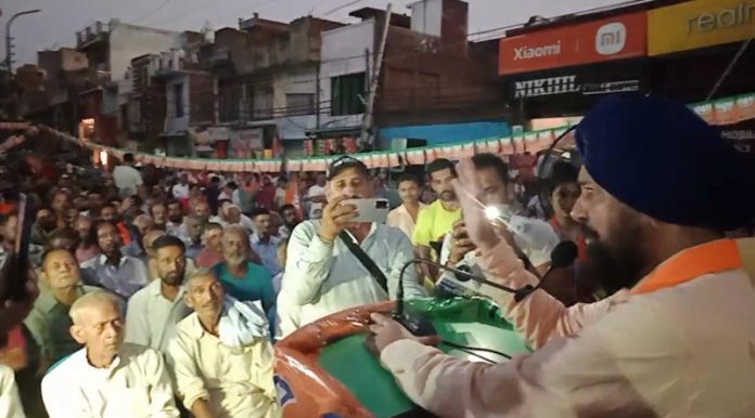 BJP leader Dr Narinder Singh Raina addressing a public meeting in RS Pura on Tuesday.