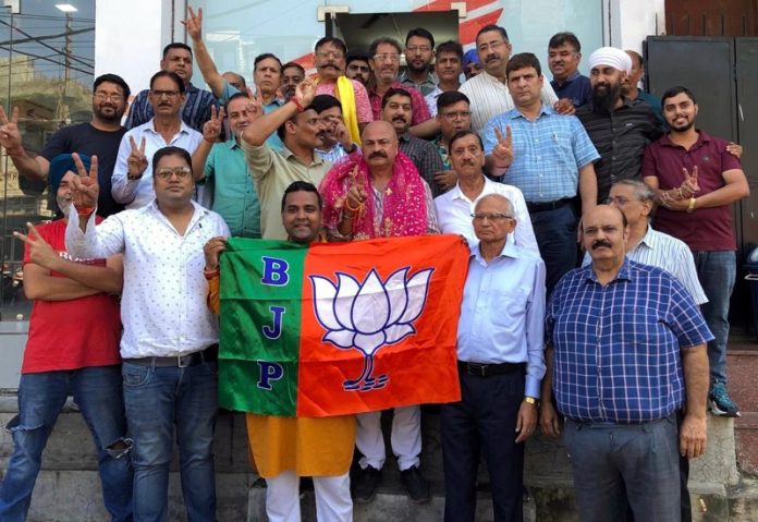 Traders of various markets of Jammu East welcoming BJP candidate, Yudhvir Sethi at a function on Wednesday.