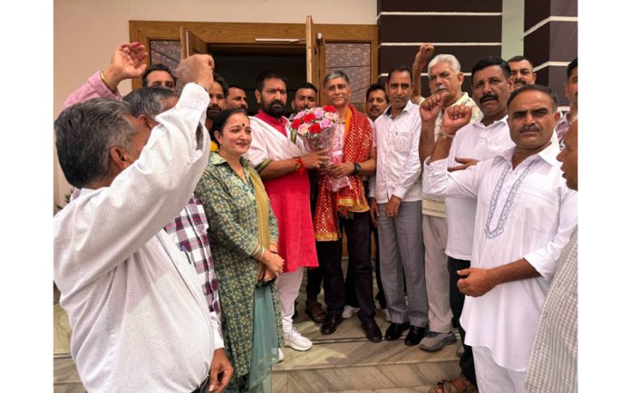 War veteran, Brig (retd) Birender Singh and his wife Sarika Jamwal posing for a photograph with BJP leaders after joining party at Marh on Tuesday.