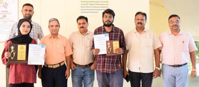 Students of SMVDU posing along with certificates and faculty members.