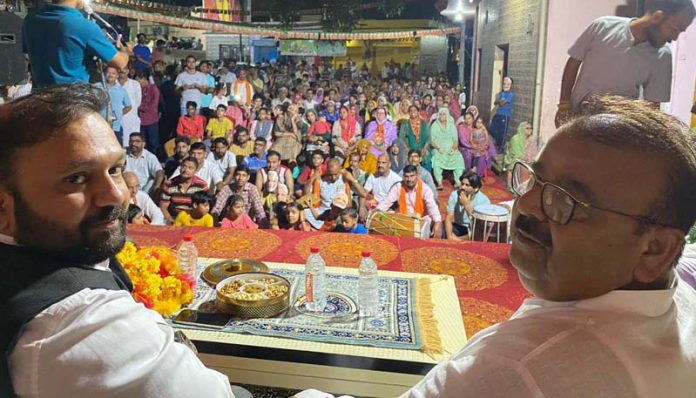 Former Minister and BJP candidate, C P Ganga and BJP leader Ankur Sharma addressing an election meeting at a village in Vijapur Assembly constituency on Saturday.