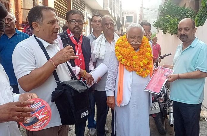 NC leader and alliance candidate, Ajay Sadhotra during door-to-door campaign in Jammu North on Monday.